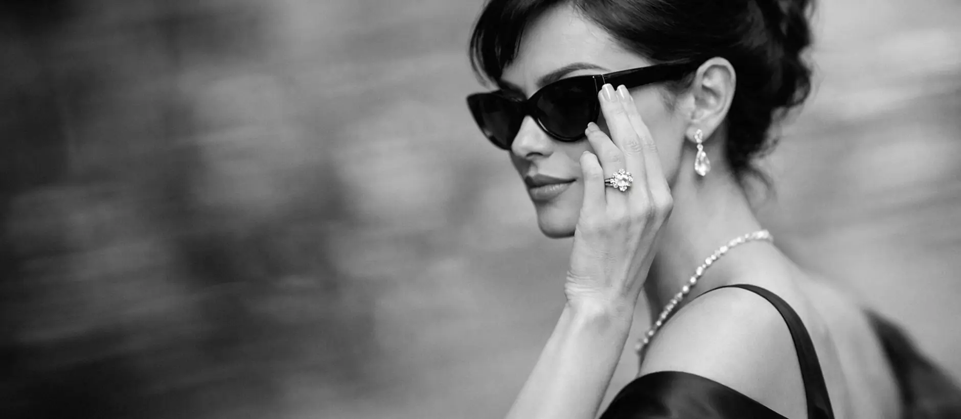 Woman wearing Evermore diamond earrings, ring and necklace